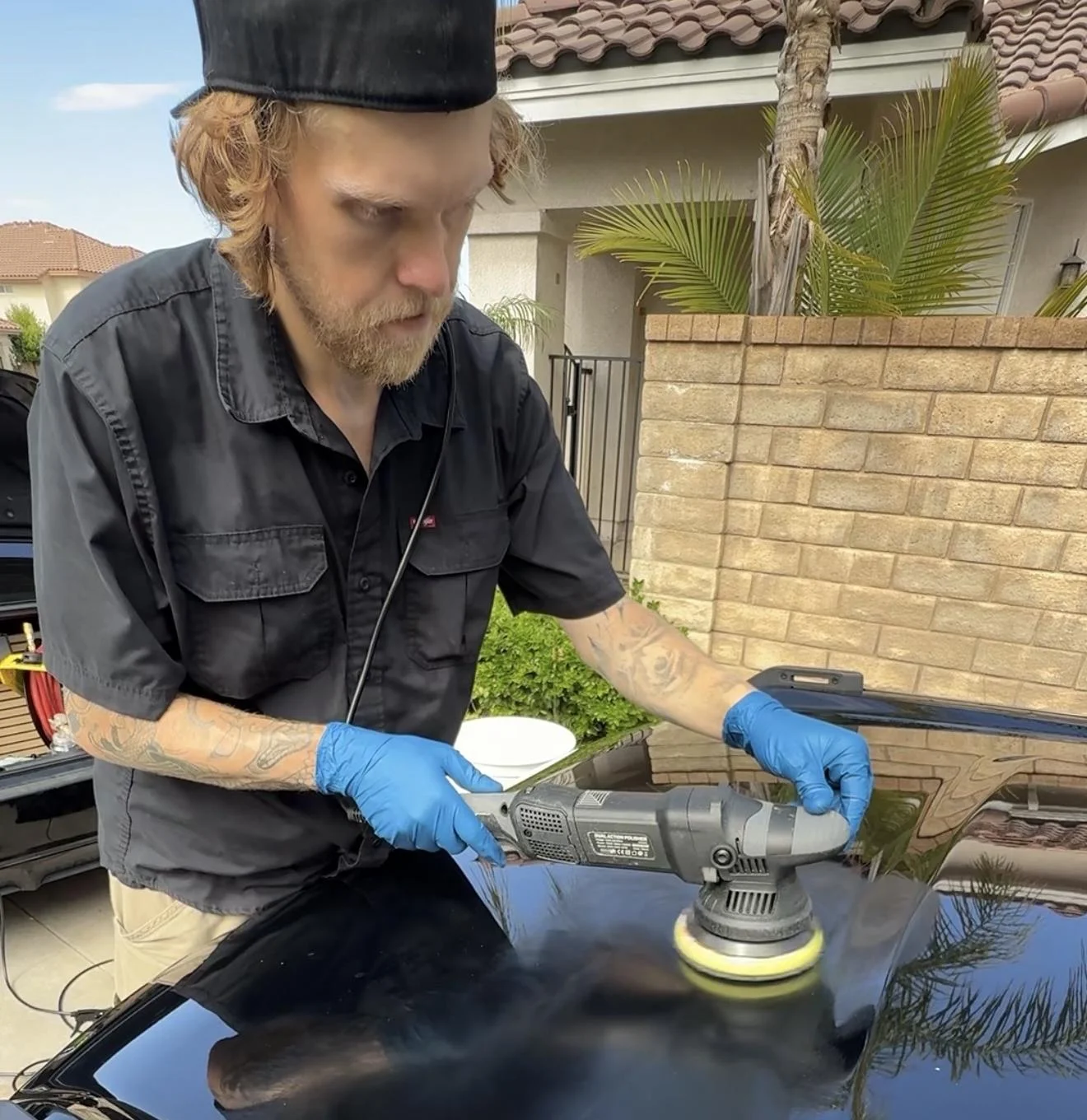 Matt Judge, owner of Gloss Haus Mobile Detailing, machine-polishing a car hood in Santa Clarita, CA